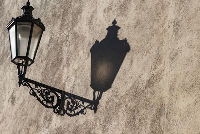 Low angle view of street light mounted on wall