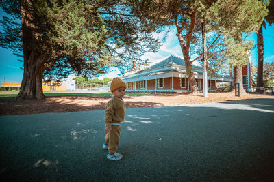 Full length of boy standing on road