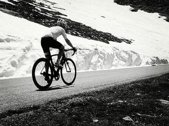 Man riding bicycle on road