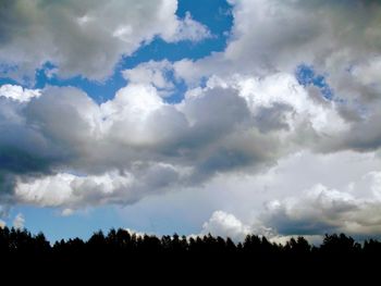 Low angle view of silhouette trees on field against sky