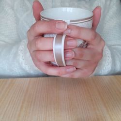 Close-up of hand holding tea cup