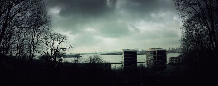 Low angle view of buildings against cloudy sky