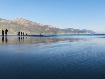 Scenic view of lake against clear blue sky