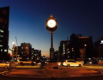 Low angle view of illuminated tower against sky at night