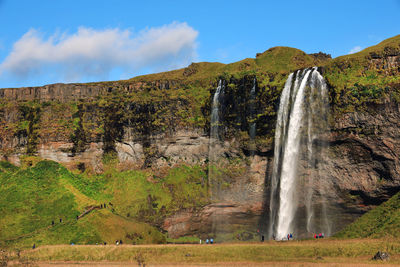 Scenic view of waterfall against sky