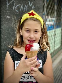 Portrait of girl holding ice cream outdoors