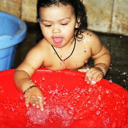 Close-up of cute girl with red water