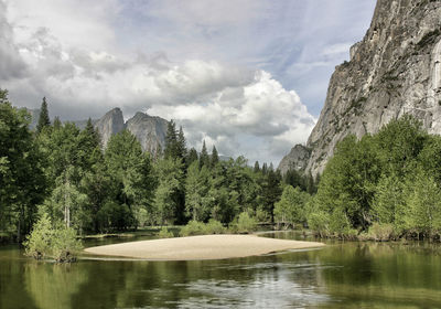 Scenic view of lake by trees against sky