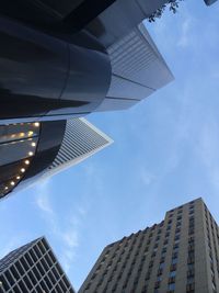 Low angle view of modern building against cloudy sky