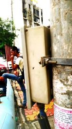 Man looking away while sitting on wall