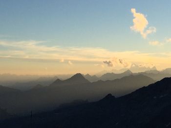 Scenic view of silhouette mountains against sky during sunset