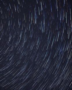 Full frame shot of star trails in sky at night