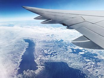 Aerial view of aircraft wing against sky