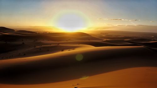 Scenic view of desert against sky during sunset