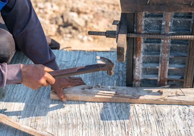 Workers nailed the pole framework slats to pour the concrete in construction site.