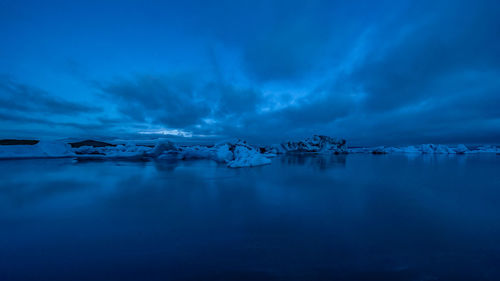 Scenic view of frozen lake against sky during winter