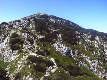 Low angle view of mountain against clear blue sky