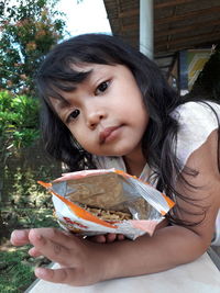 Portrait of woman holding ice cream