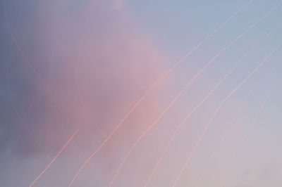 Low angle view of vapor trails against sky