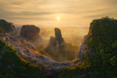 Rock formations against sky during sunset