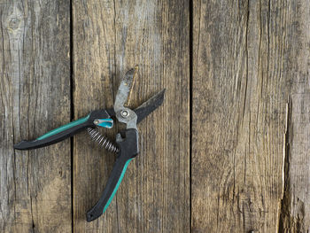 Directly above view of pliers on wooden table