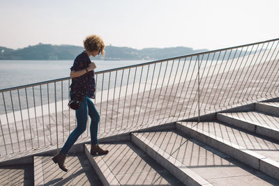 Woman walking on steps in city 