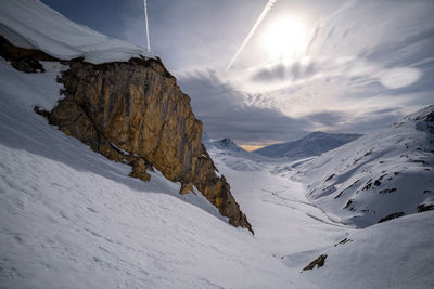 Scenic view of snow covered mountains against sky