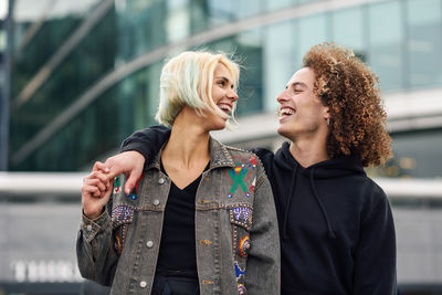 Happy couple standing in city