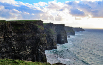 Scenic view of sea against cloudy sky