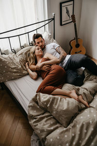 Woman lying on bed at home