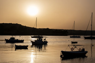 Boats in marina at sunset