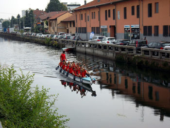 Boats in river with buildings in background