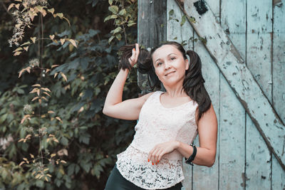 Portrait of a smiling young woman standing outdoors