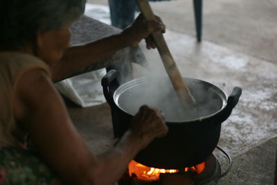 Midsection of man preparing food