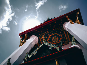 Low angle view of illuminated building against sky