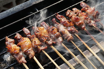 High angle view of meat on barbecue grill