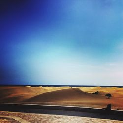 Scenic view of field against blue sky