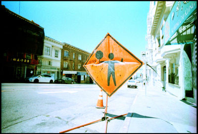 Close-up of road sign against built structures