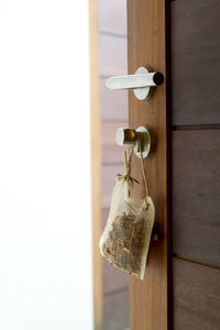 Close-up of sack hanging on wooden door