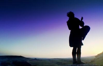 Silhouette of woman standing on landscape