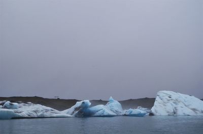 Scenic view of frozen lake against clear sky