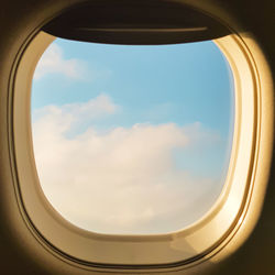 Cloudy sky seen through airplane window