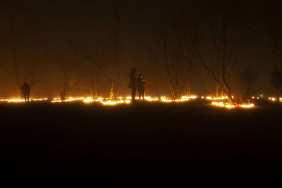 People at illuminated cemetery