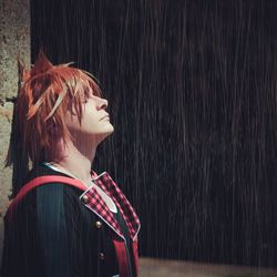 Portrait of young woman in rain