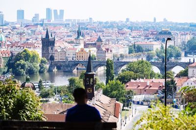 Rear view of man standing against cityscape