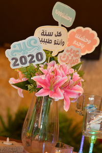 Close-up of pink flowers in glass vase on table