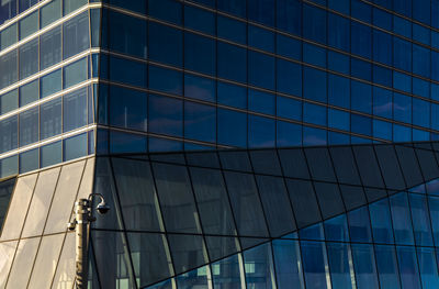 Low angle view of modern glass building in madrid, spain