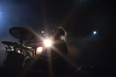 Low angle view of illuminated lighting equipment at night