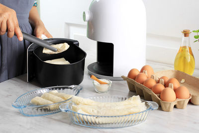 Cropped hand of person preparing food