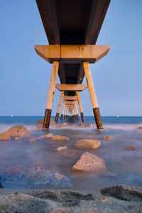 Scenic view of a bridge over the beach against clear sky